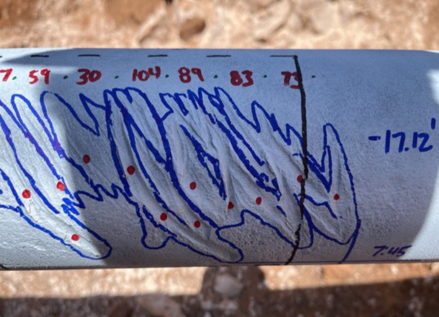 Image of gouges circled by blue marker on outside of pipe